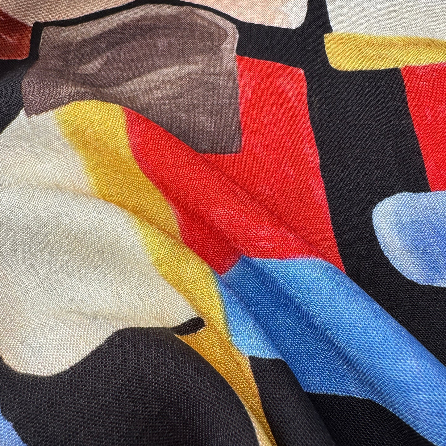 Close up of the texture on abstract multicolour geometric textured viscose fabric