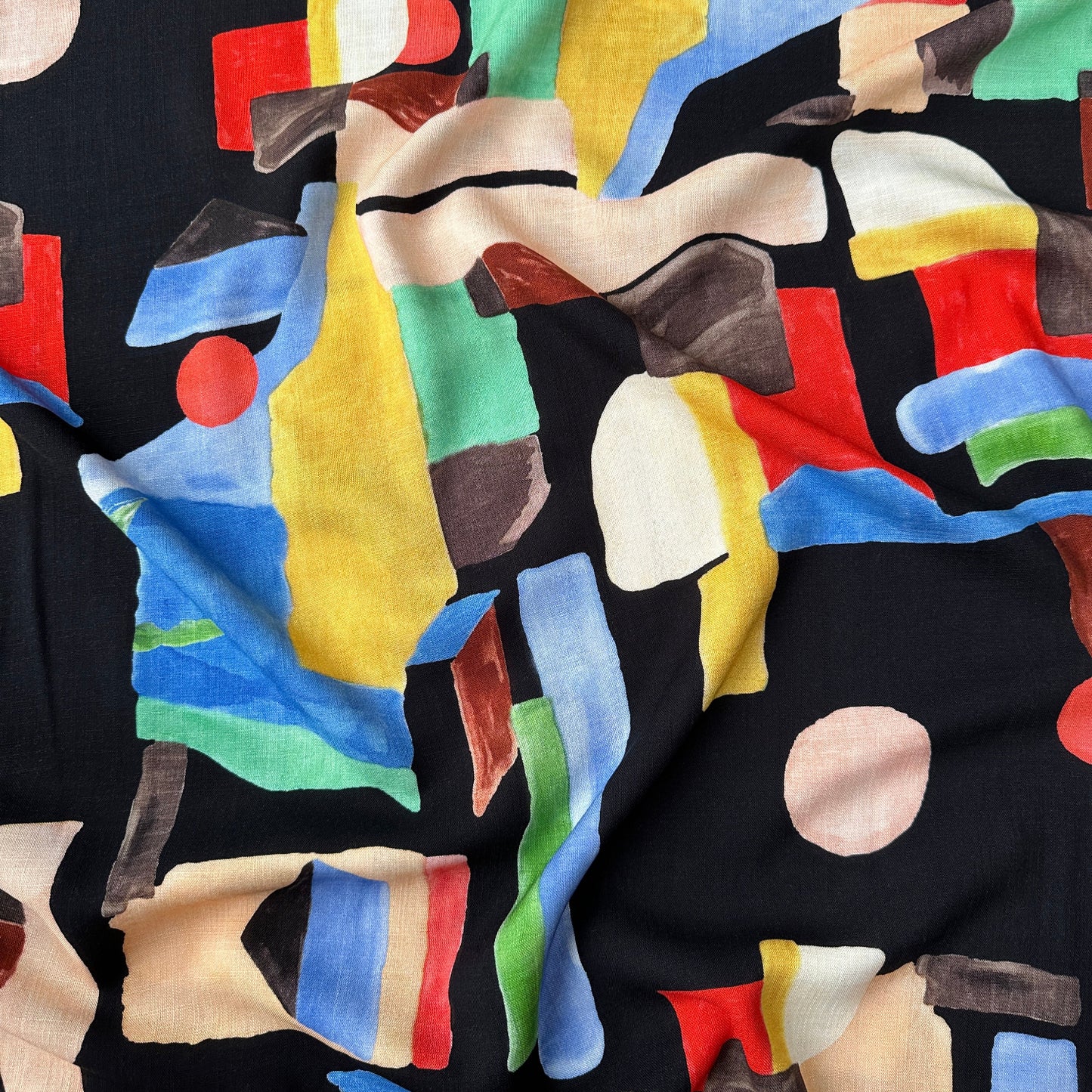 Colourful abstract shapes on a black fabric