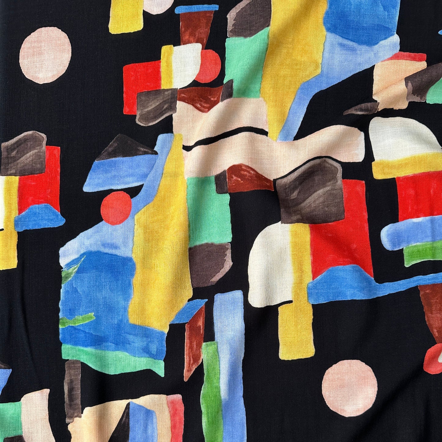 Fabric with colourful abstract pattern on a black background