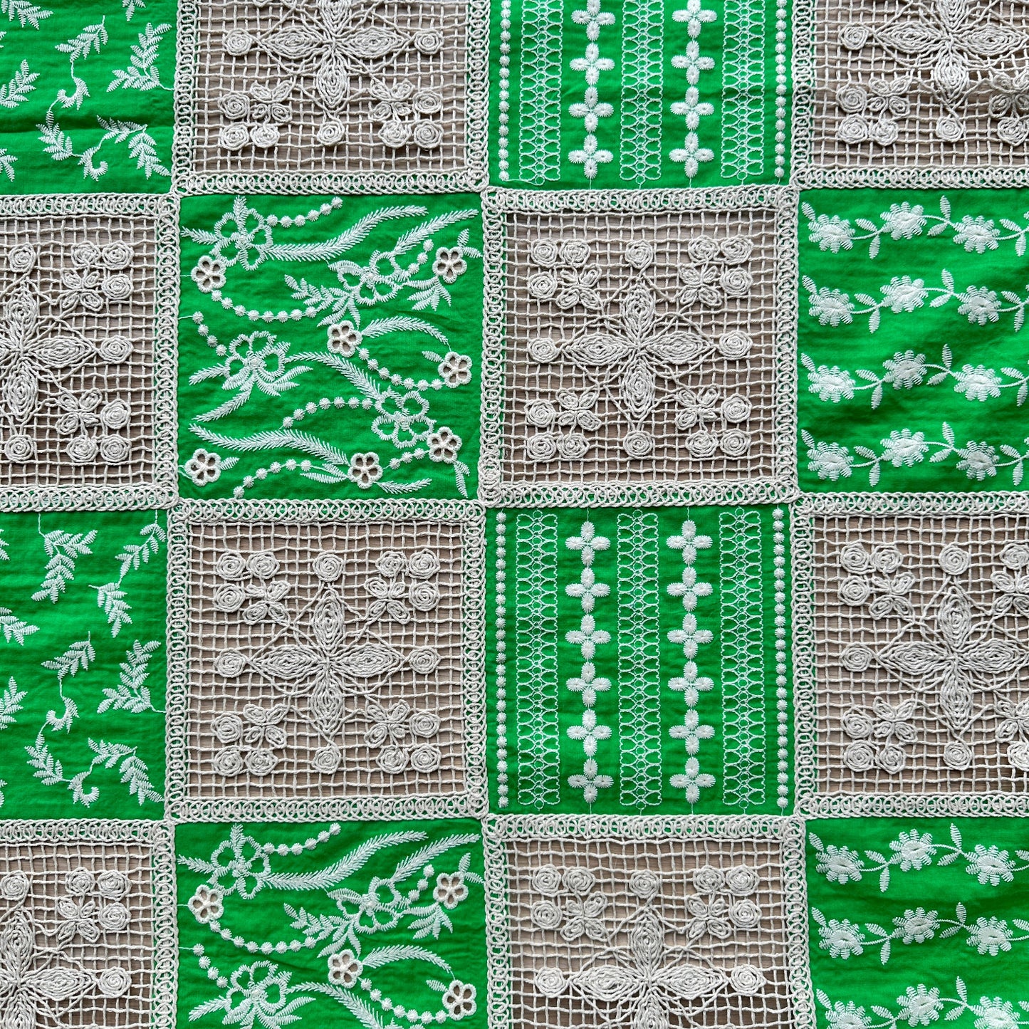Green and white embroidered cotton patchwork fabric