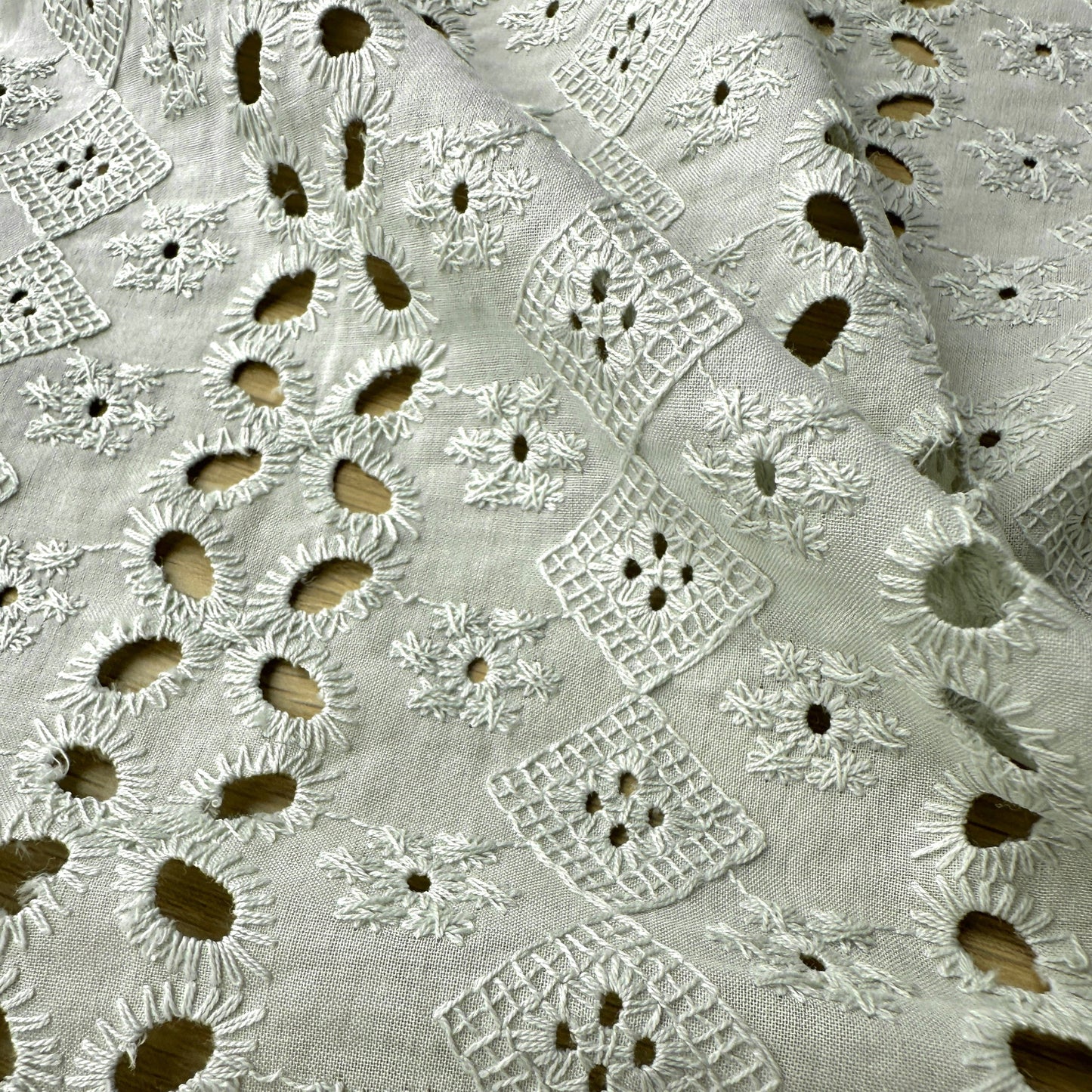 Close up of the embroidery and cut outs on embroidery anglaise fabric