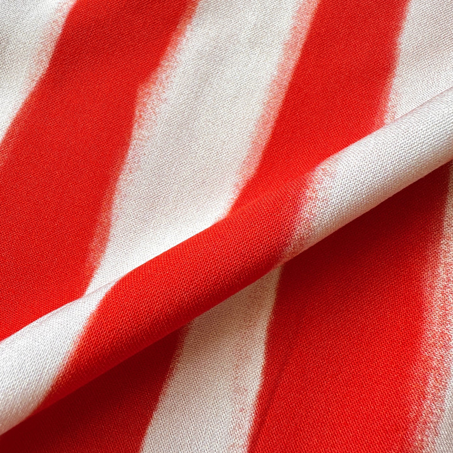 Close up of painted stripes viscose fabric