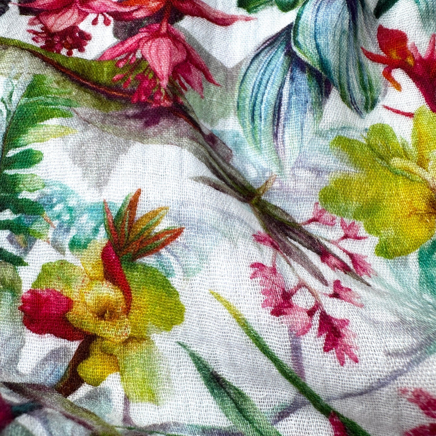 Close up of a fabric with colourful floral and leaf pattern