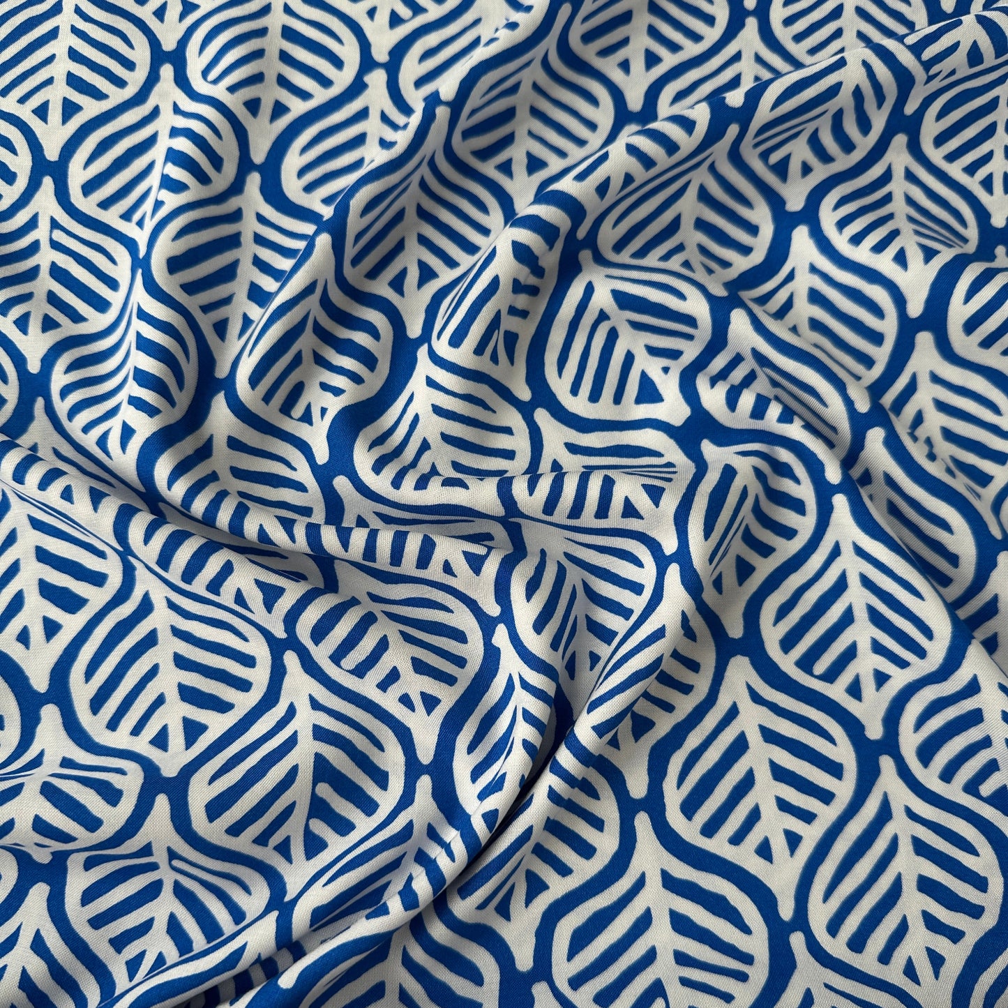 Blue viscose fabric with white leaves