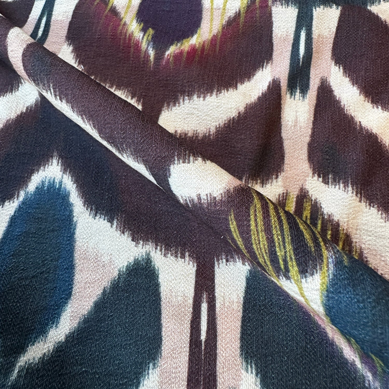Close up of abstract floral viscose blend dressmaking fabric