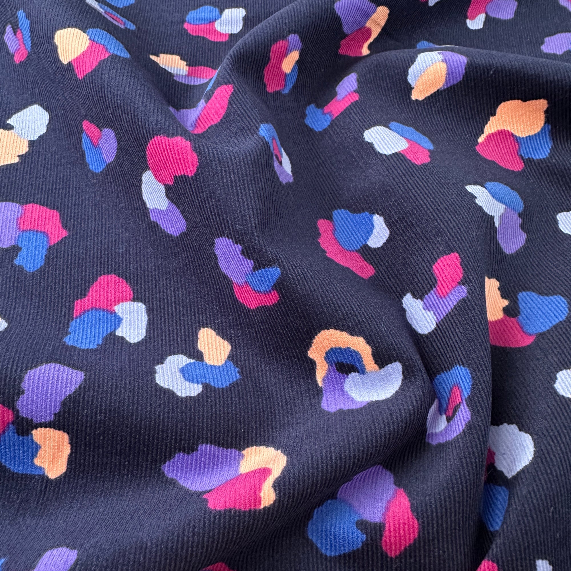 Close up of babycord fabric showing the abstract animal print