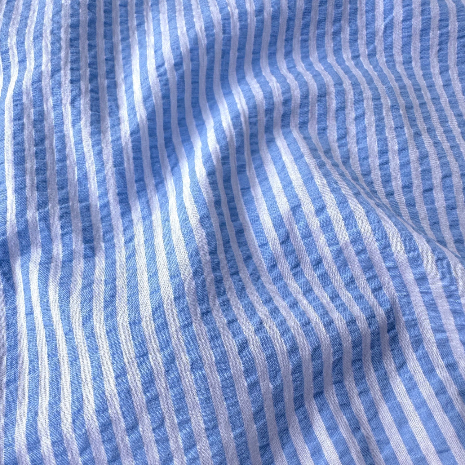 Close-up of blue and white striped seersucker fabric