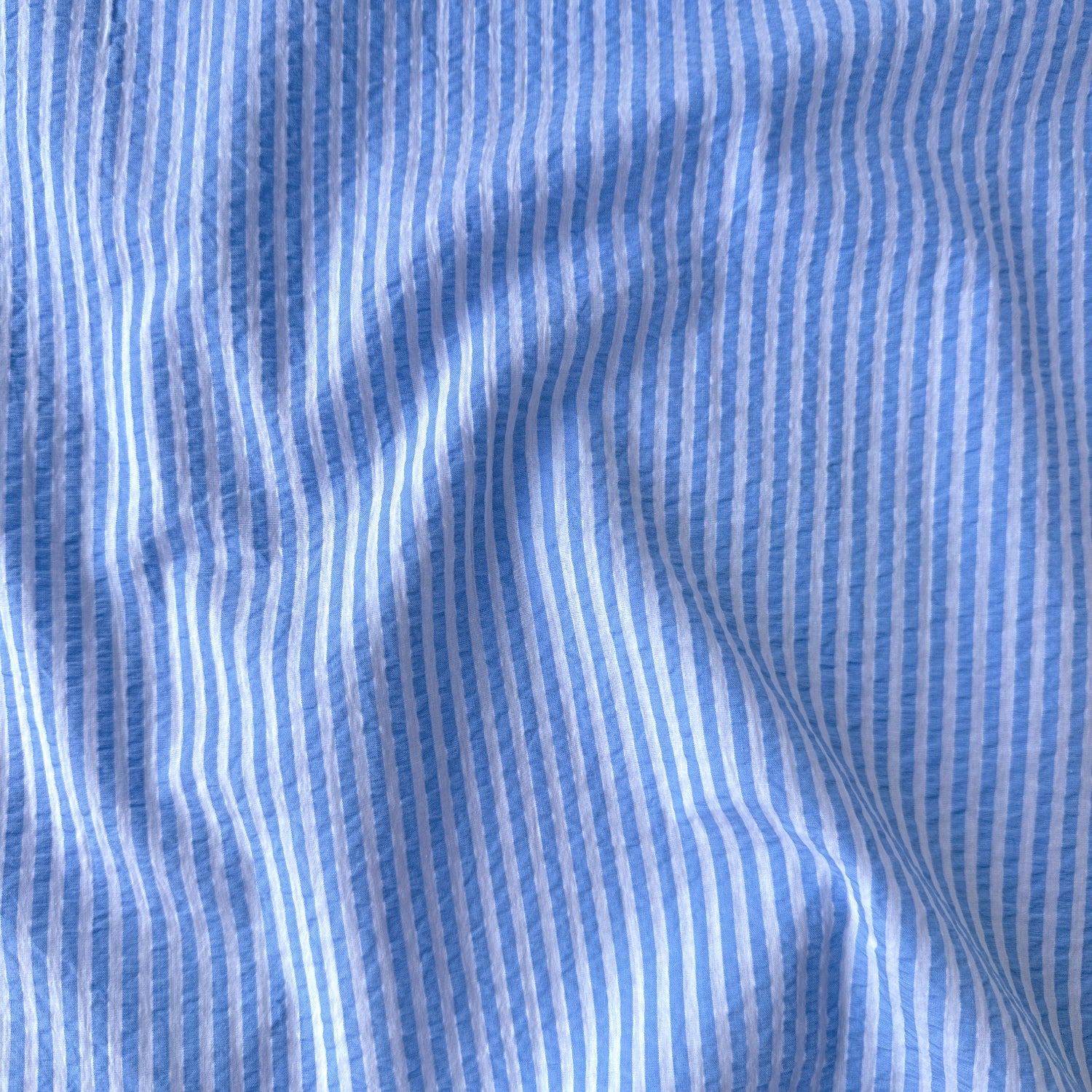close up of Baby Blue and White Striped Cotton Seersucker Fabric