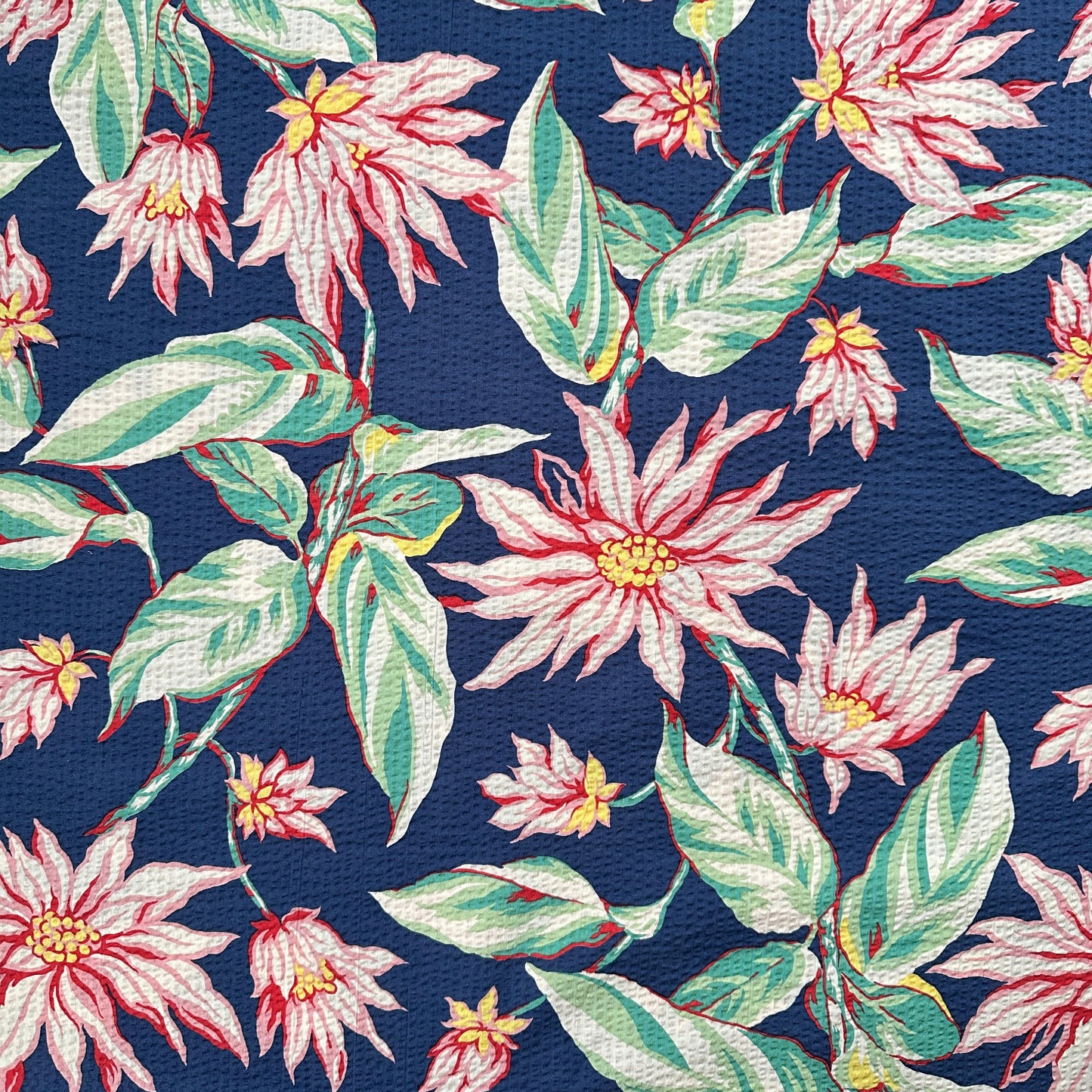 Floral pattern with pink flowers and green leaves on a navy blue background