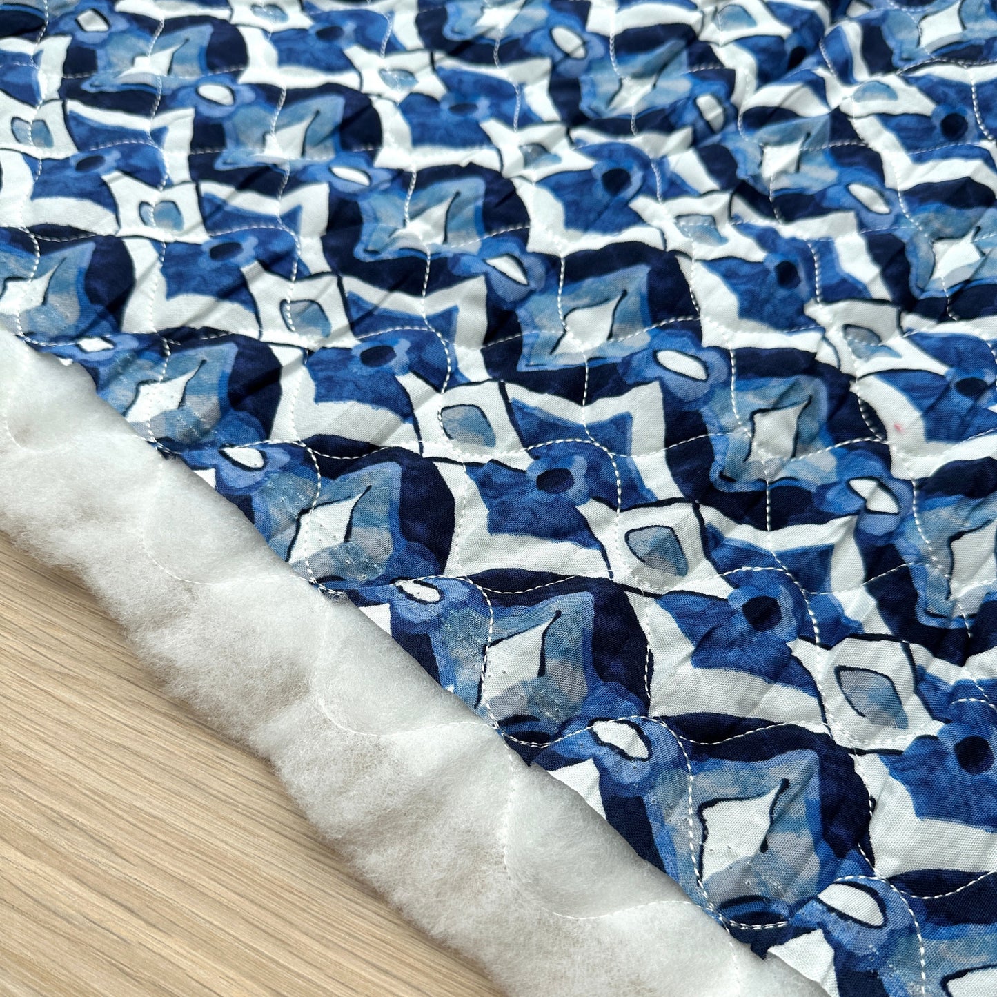 Blue diamonds quilted fabric with white wadding