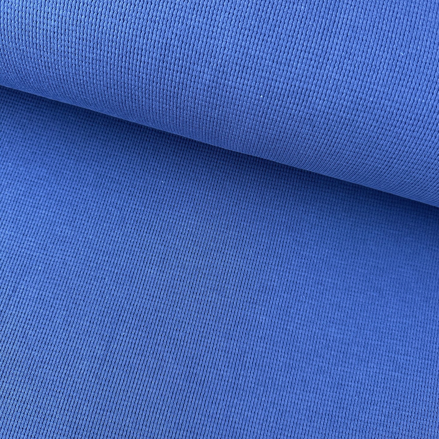 Close-up of blue fabric with a waffle texture