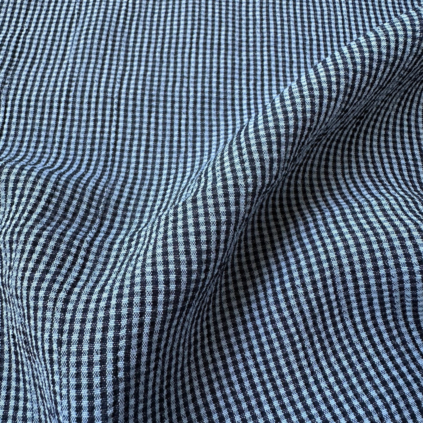 Blue and navy gingham textured viscose blend fabric