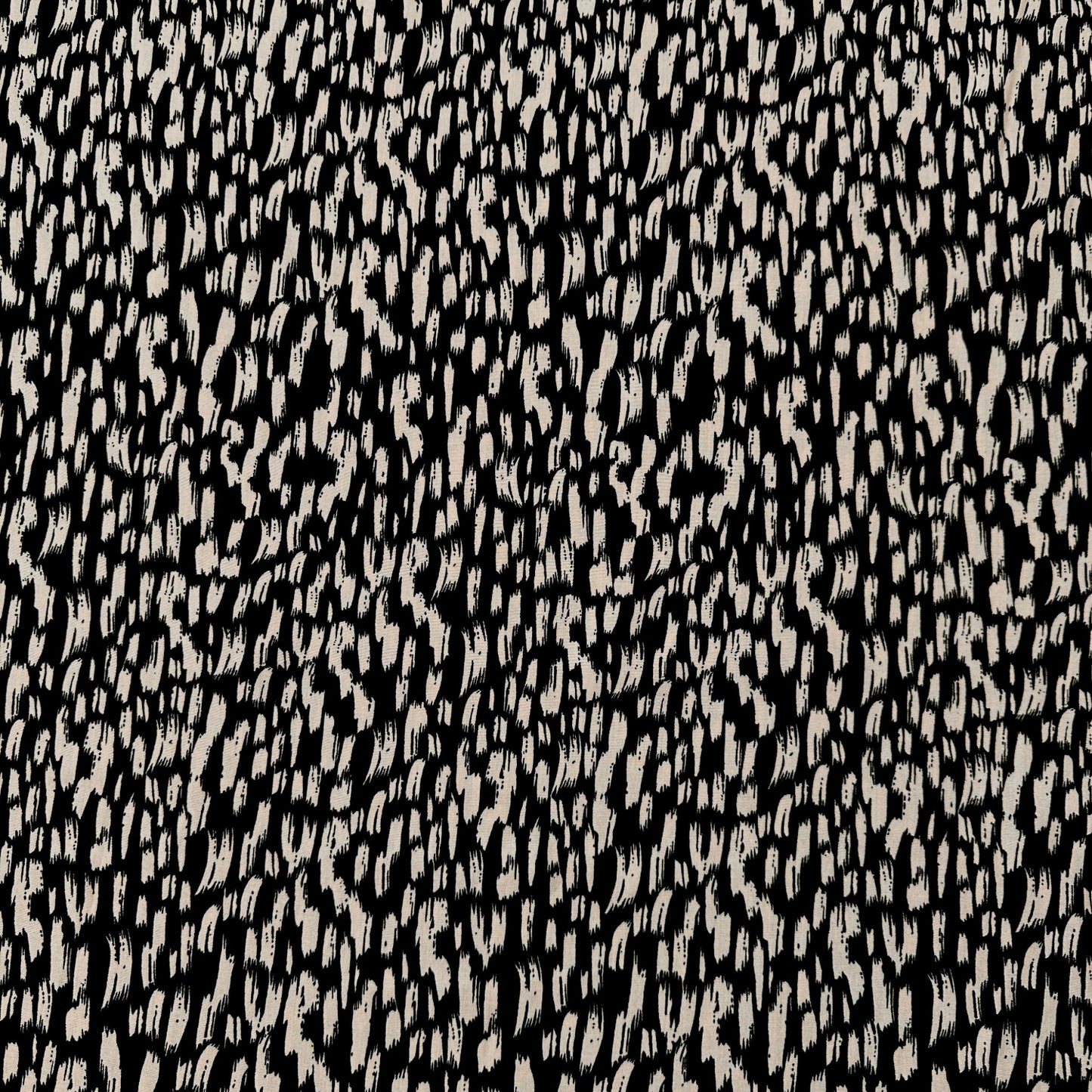Dressmaking fabric with a black background with brushstrokes in fawn across it