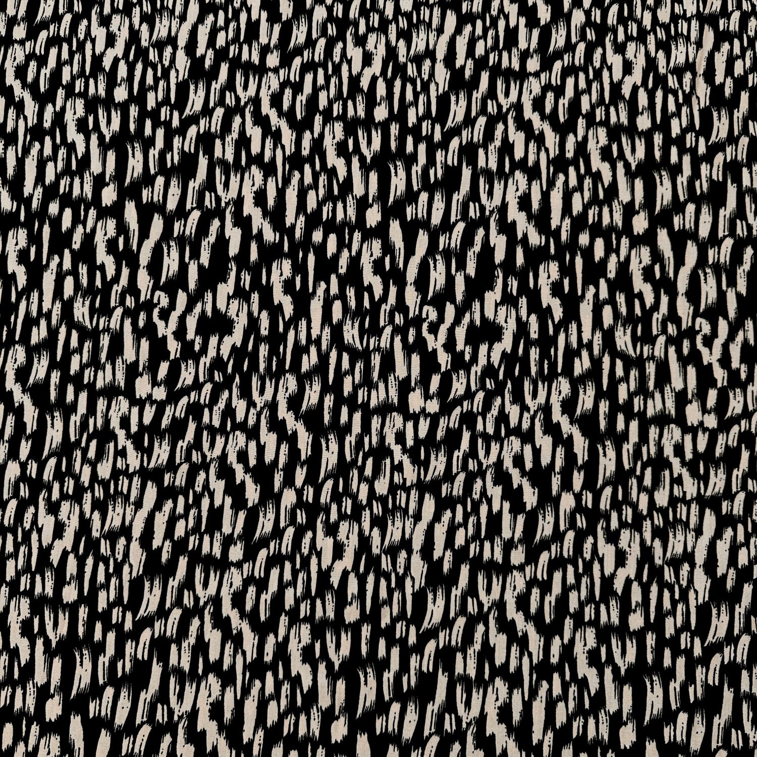 Dressmaking fabric with a black background with brushstrokes in fawn across it