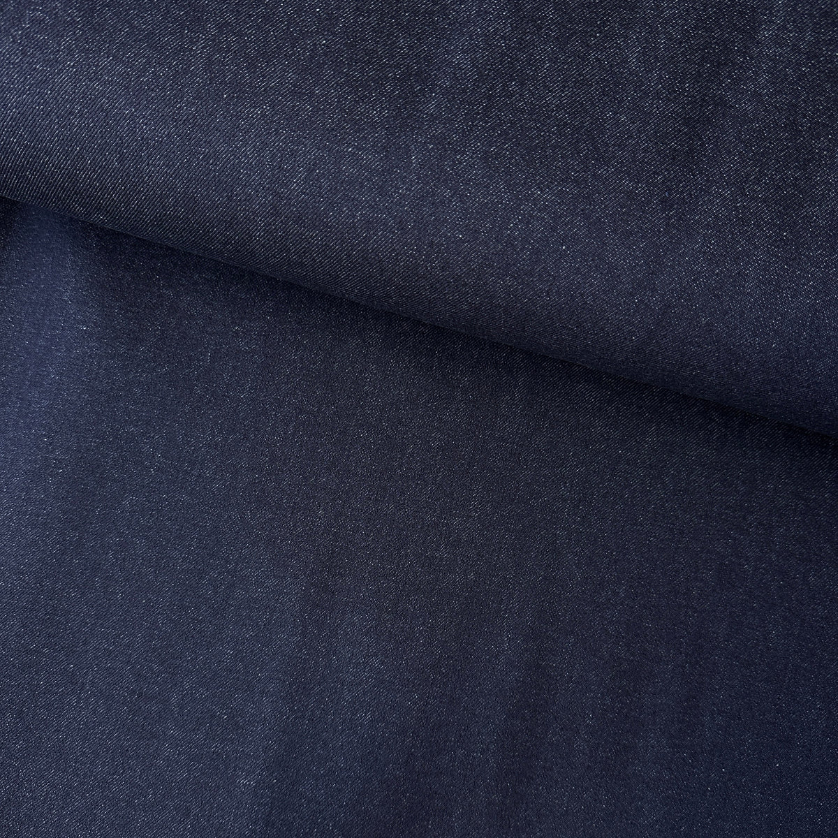A close-up of dark indigo denim fabric