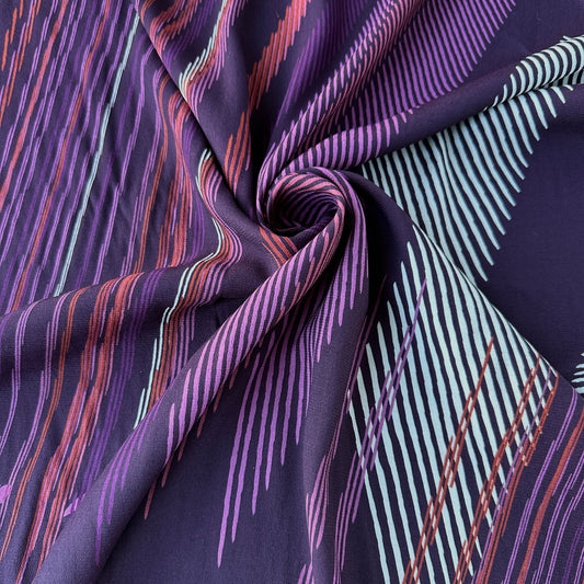 Close up of striped fabric with purple and white pattern