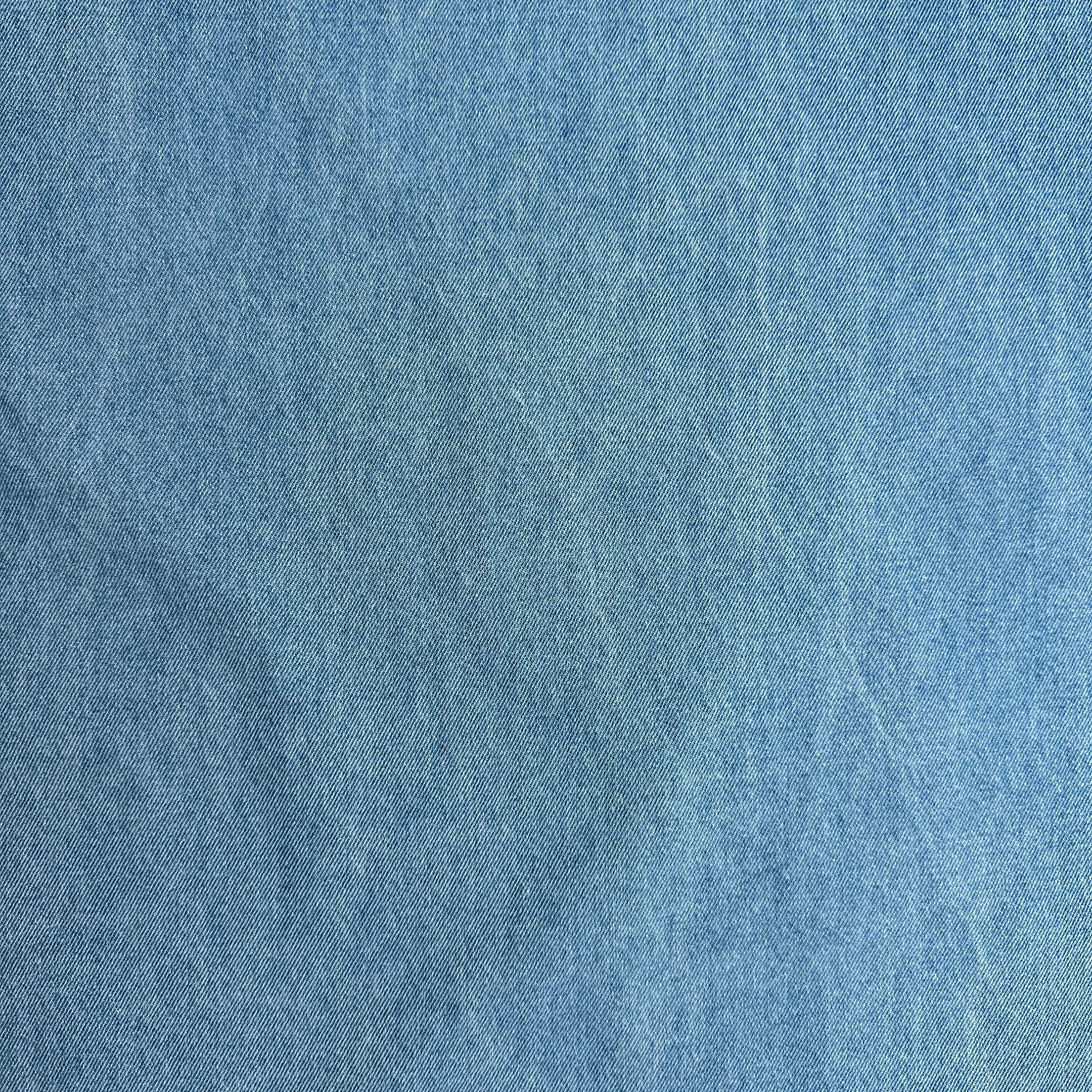 Distressed effect on blue cotton denim fabric