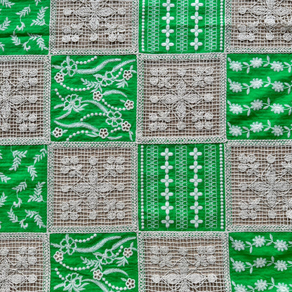 Green and white embroidered cotton patchwork fabric