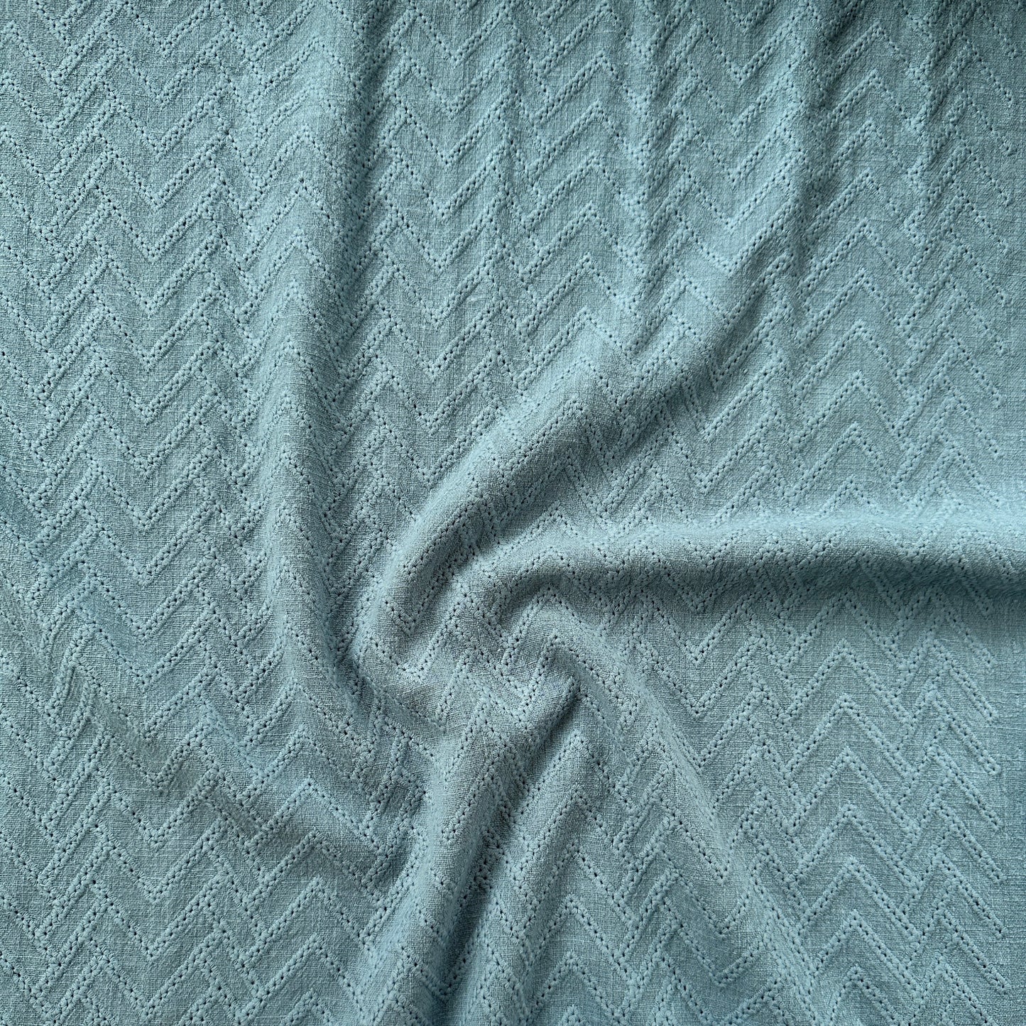A close-up of a textured blue fabric