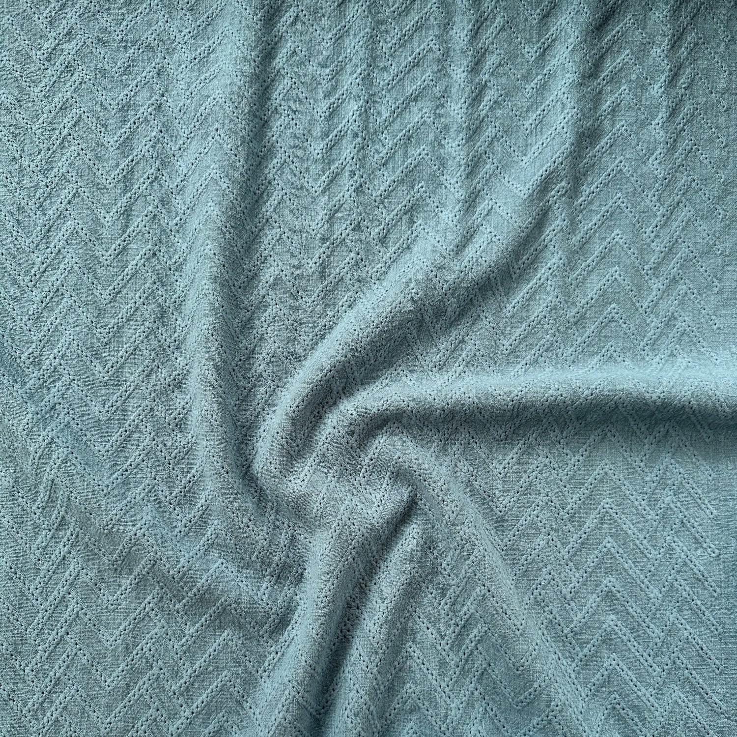 A close-up of a textured blue fabric
