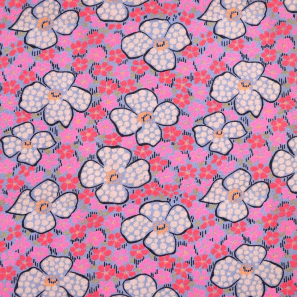 Fabric with flowers across a background of pink and red flowers