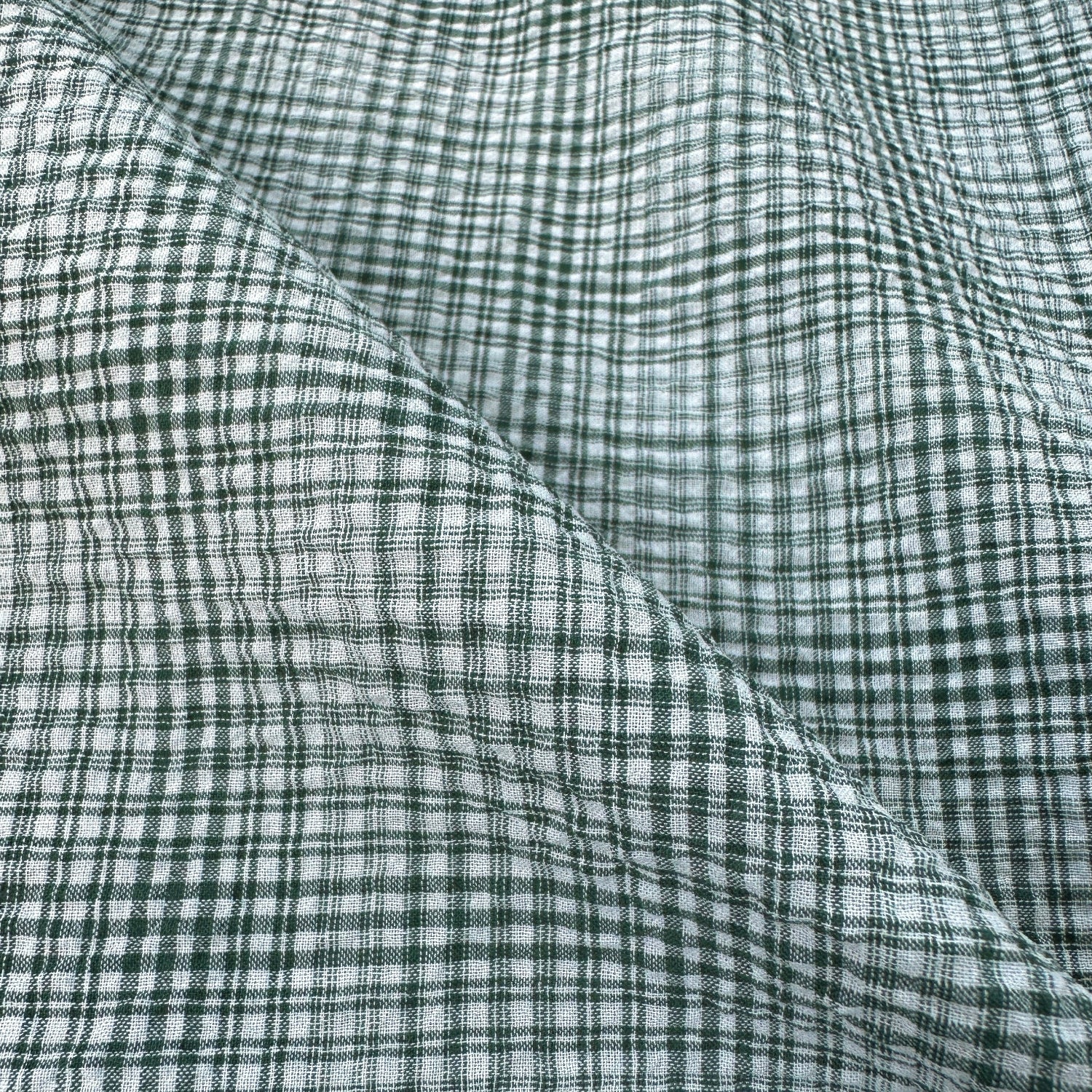 Close up of green check seersucker dressmaking fabric