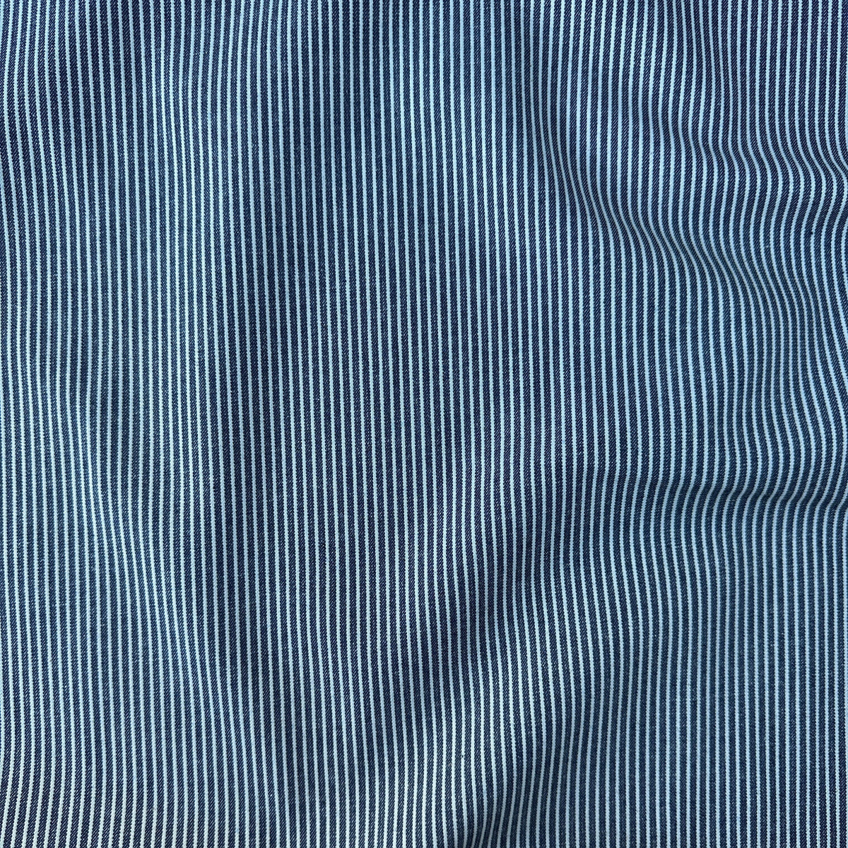 Close-up of a blue and white vertically striped denim fabric