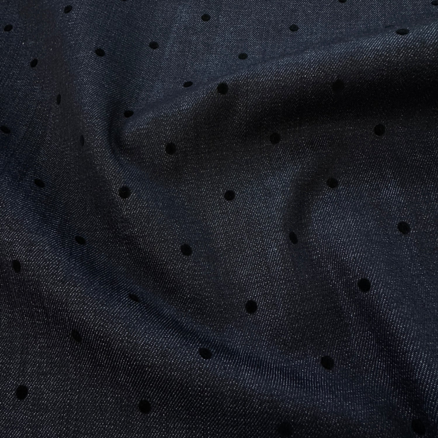 Dark indigo denim fabric with small black velvet dots
