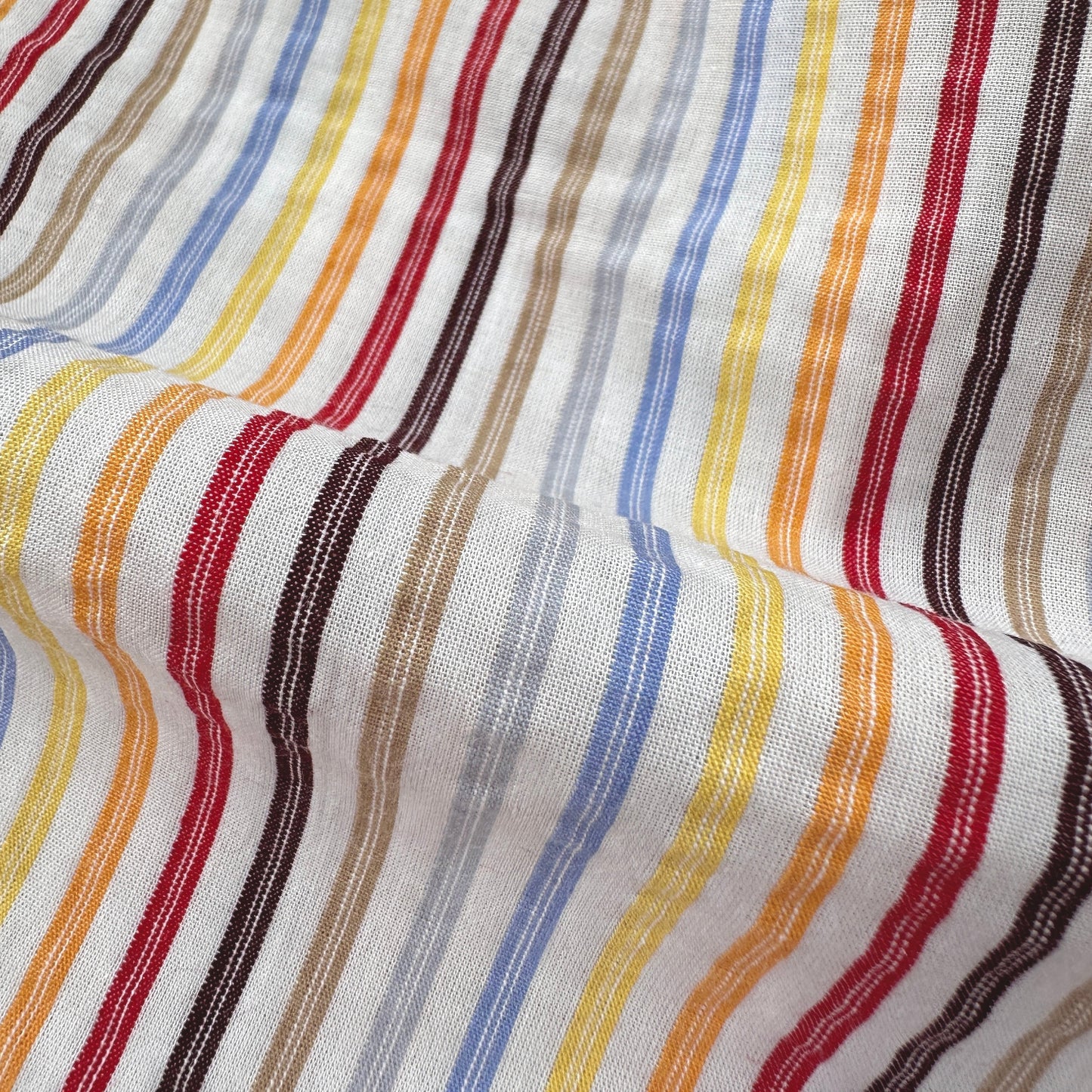 Close-up of fabric with multicoloured stripes on a white background