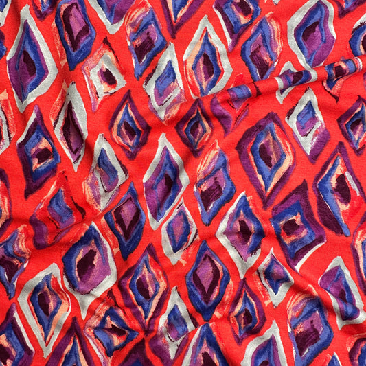 Fabric with geometric pattern on a bright red background