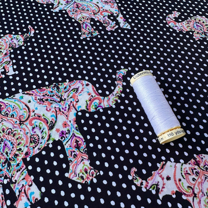 Paisley Elephants on Polka Dot Cotton Poplin Fabric With Reel of Thread for Scale