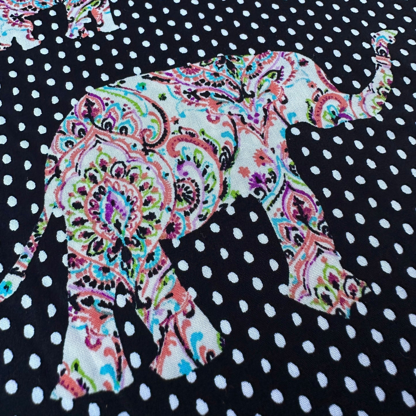 Colourful elephant design on a black and white polka dot background