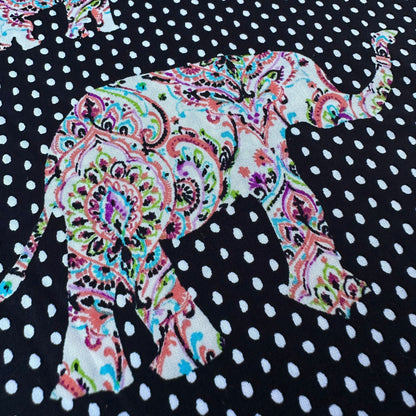 Colourful elephant design on a black and white polka dot background