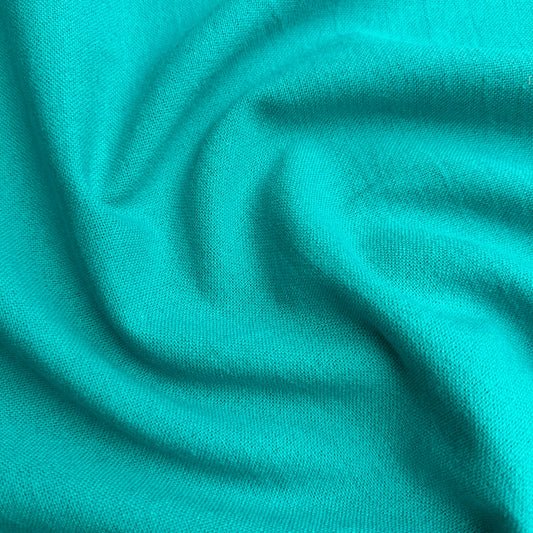 Close up of peacock cotton linen fabric with folds
