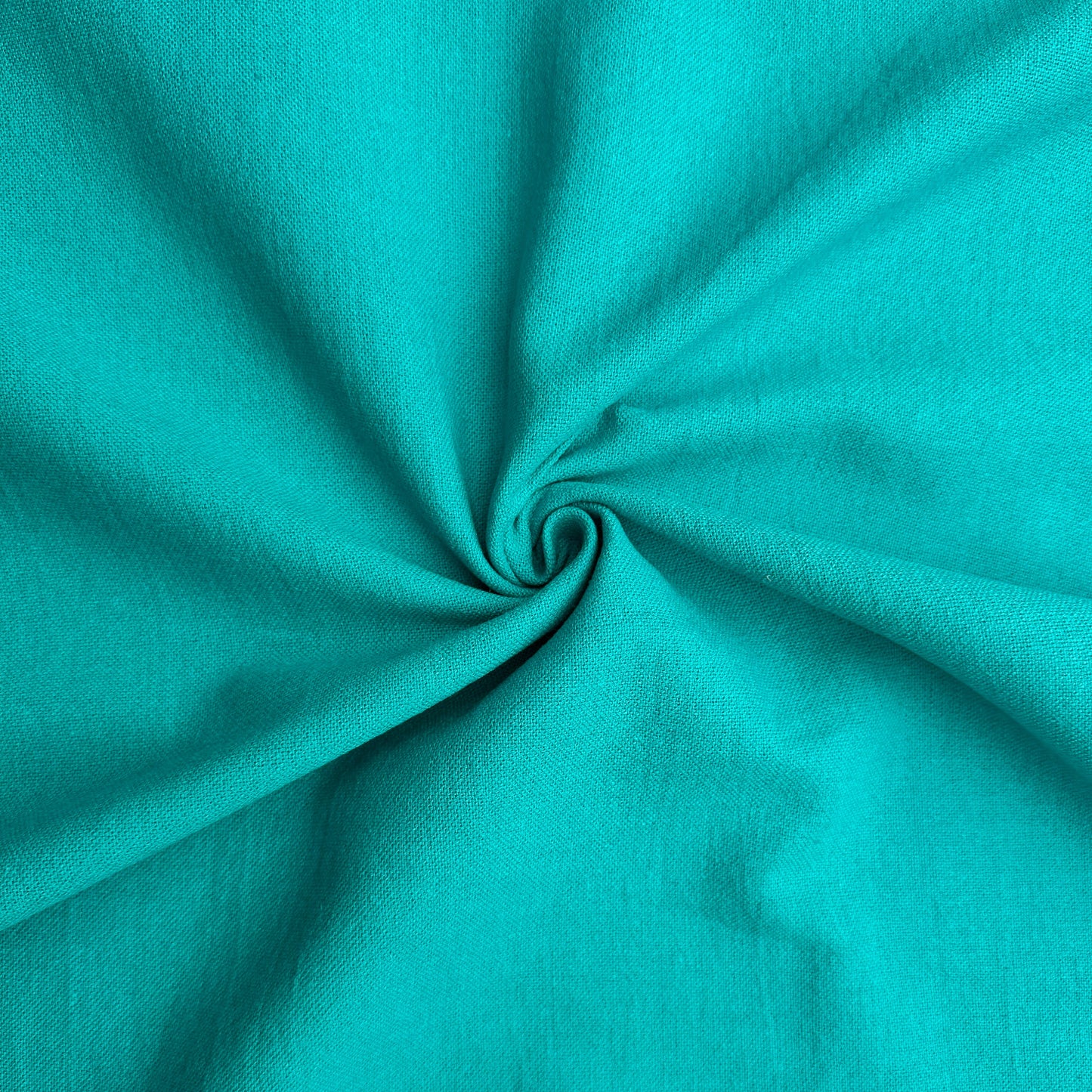 Linen Cotton Blend Fabric in Peacock swirled to show the texture