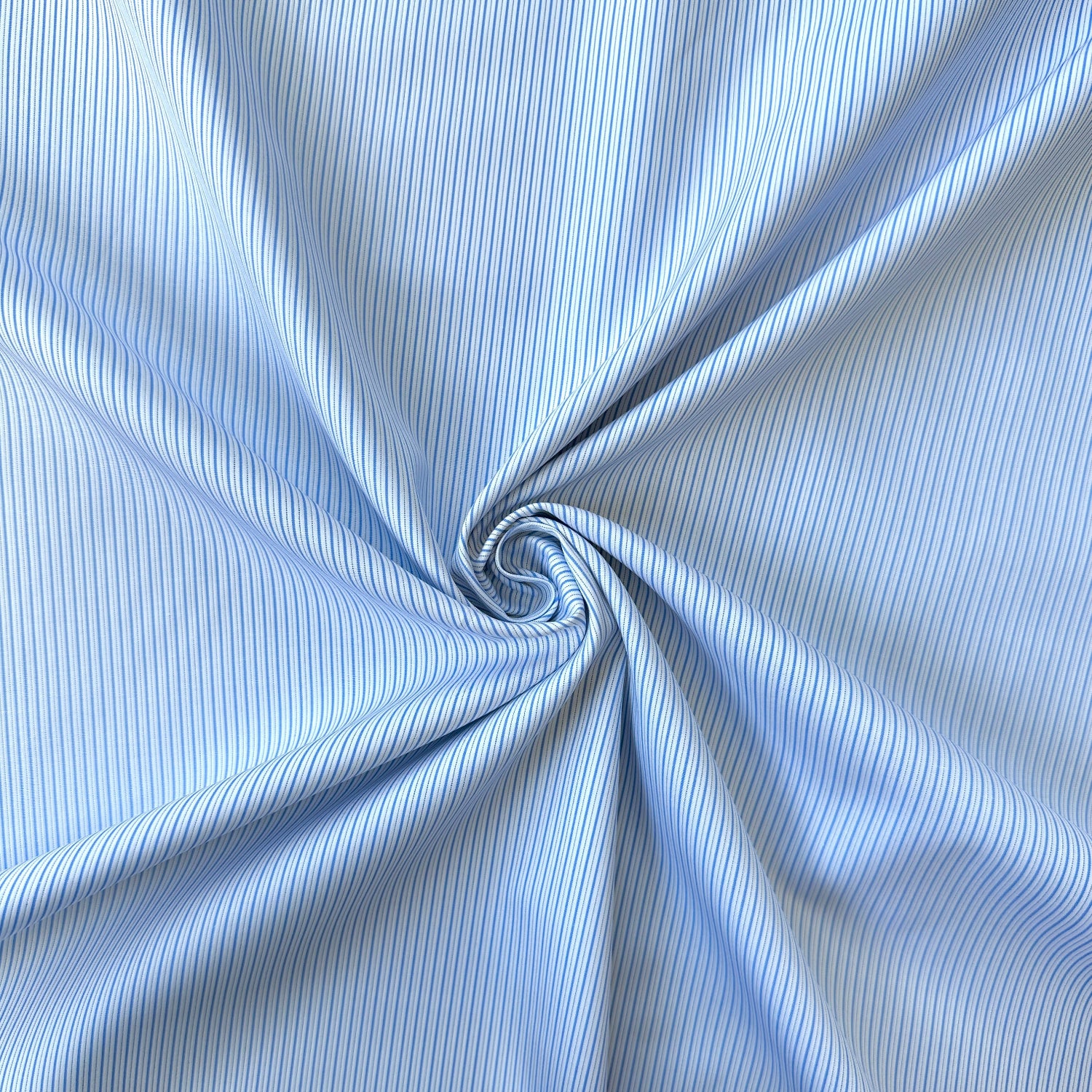 Close up of a swirl of blue striped cotton fabric