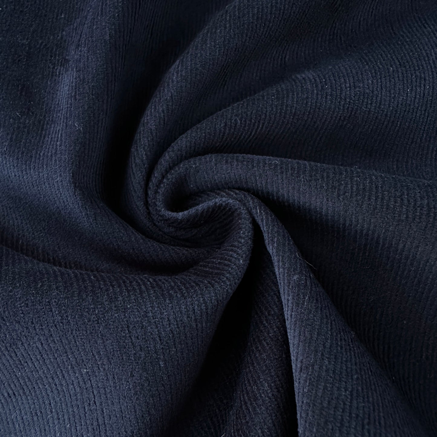 Close up of dark blue needlecord fabric
