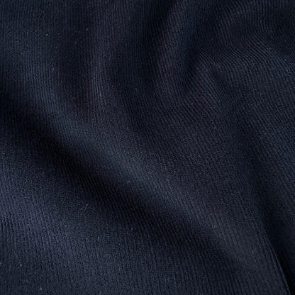 Close up of dark blue needlcord fabric texture