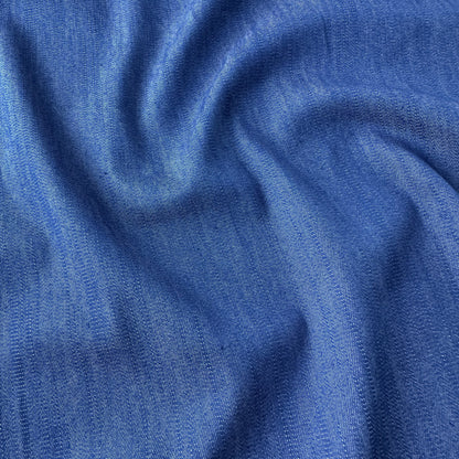 Close up of blue denim chambray fabric with a textured pattern
