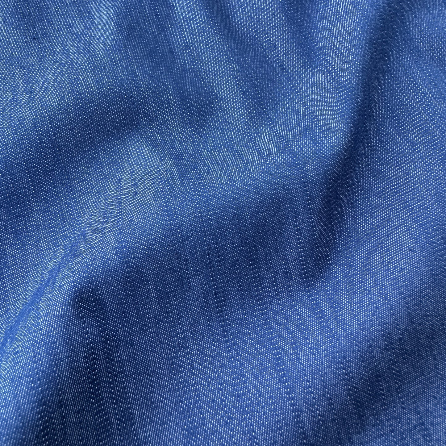 Close up of blue chambray fabric with visible texture