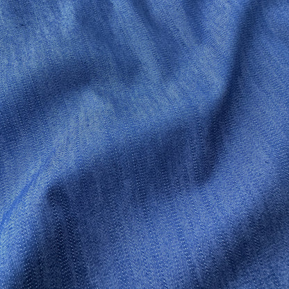 Close up of blue chambray fabric with visible texture