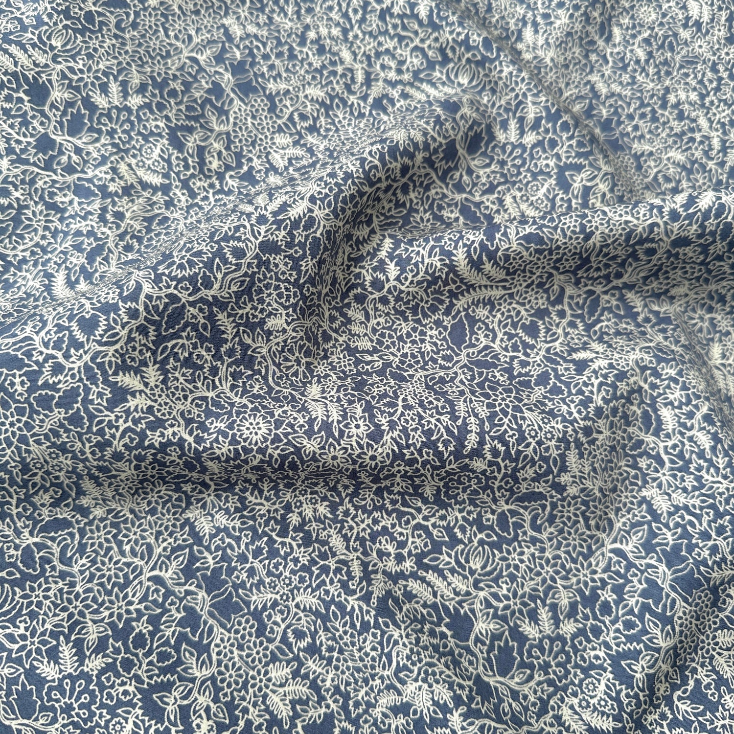 Floral patterned fabric with blue and white colors