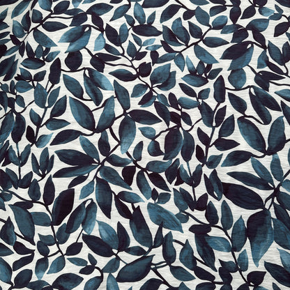 Pattern of blue leaves on an off white fabric background