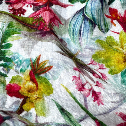 Close up of a fabric with colourful floral and leaf pattern