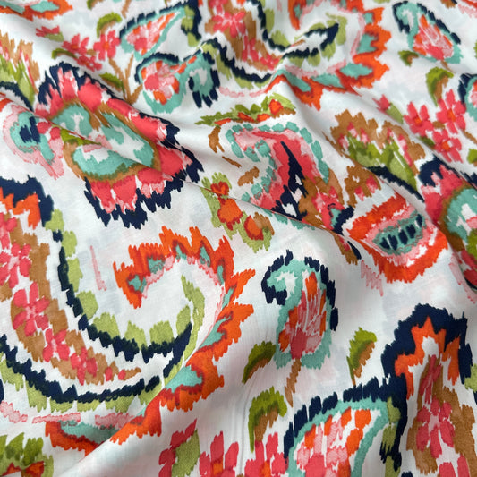Pima cotton lawn fabric with a colourful watercolour paisley across a light background