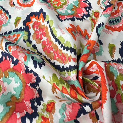 Watercolour paisley cotton lawn fabric in coral close up