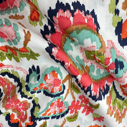 Coral, navy, pink, green and orange paisley pattern across an off white pima cotton lawn fabric