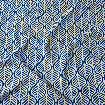 White leaves on cobalt blue viscose dressmaking fabric
