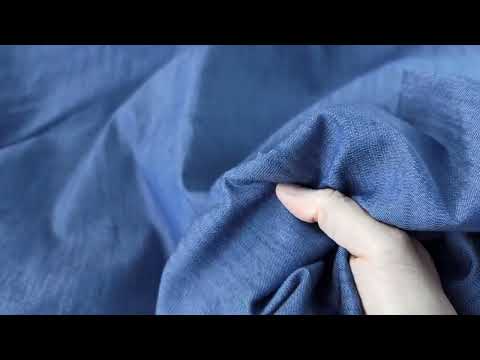 Video showing textured stretch denim chambray fabric in blue